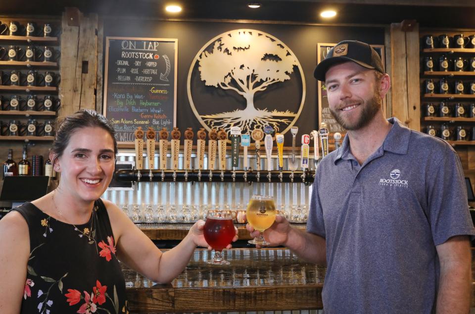 Brian Shadduck, partner, and Laura Dennie, events planner, at the tasting bar at the reopened Rootstock Ciderworks in Williamson Wednesday, May 22, 2024.