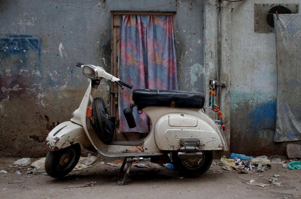 <p>A Vespa scooter stands near a workshop, where old Vespa parts are painted, on a street in Karachi, Pakistan, Feb. 28, 2018. (Photo: Akhtar Soomro/Reuters) </p>