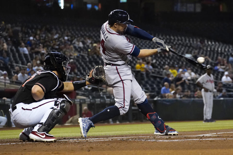 Atlanta Braves' Adam Duvall connects for a two run home run against the Arizona Diamondbacks during the first inning of a baseball game, Wednesday, Sept. 22, 2021, in Phoenix. (AP Photo/Matt York)