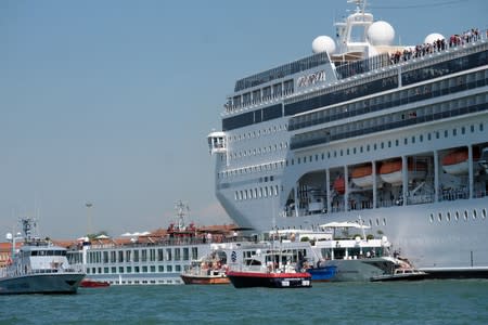 The cruise ship MSC Opera loses control and crashes against a smaller tourist boat at the San Basilio dock in Venice