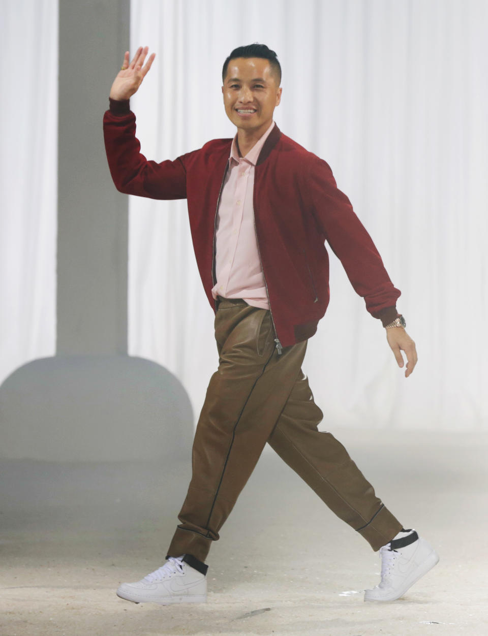 Desigjner Phillip Lim acknowledges audience applause after his Spring 2014 collection was modeled during Fashion Week in New York, Monday, Sept. 9, 2013. (AP Photo/Richard Drew)