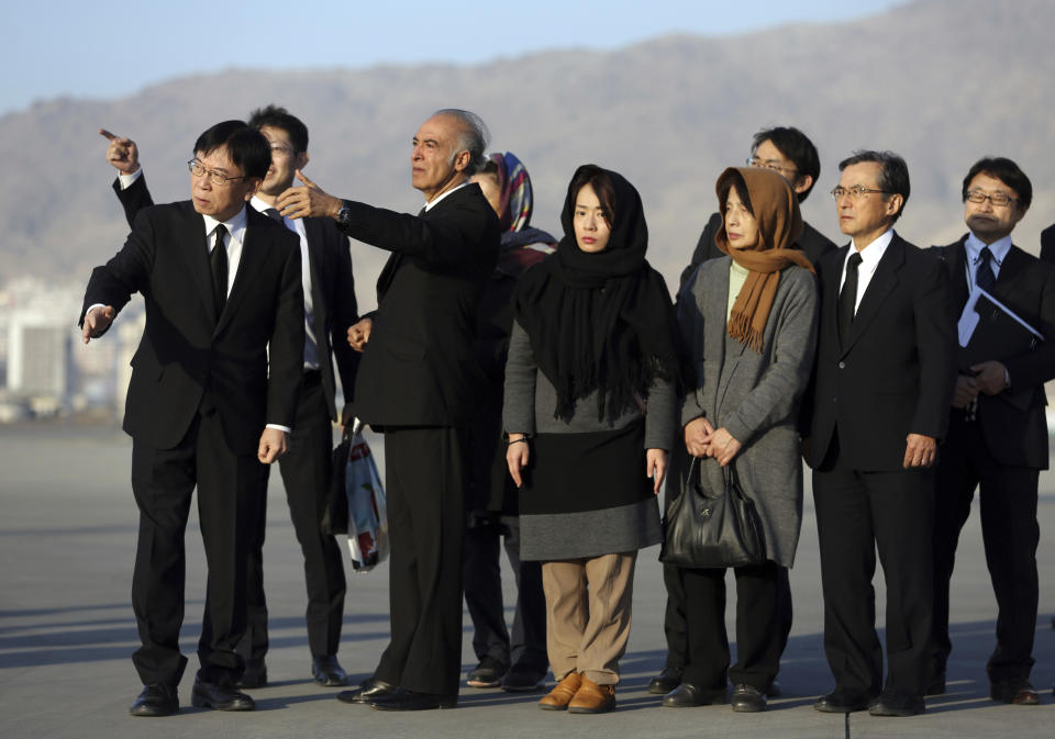 From right, fourth Naoko Nakamura, wife and fifth, Akiko Nakamura, daughter of slain Japanese physician Tetsu Nakamura stand during a ceremony before transporting his body to his homeland, at the Hamid Karzai International Airport in Kabul, Afghanistan, Saturday, Dec. 7, 2019. Nakamura was killed earlier this week in a roadside shooting in eastern Afghanistan. (AP Photo/Rahmat Gul)