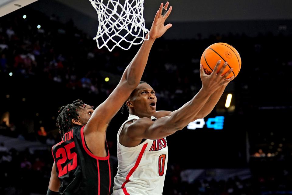 Mar 24, 2022; San Antonio, TX, USA; Arizona Wildcats guard Bennedict Mathurin (0) drives to the basket against Houston Cougars center Josh Carlton (25) during the second half in the semifinals of the South regional of the men's college basketball NCAA Tournament at AT&T Center.