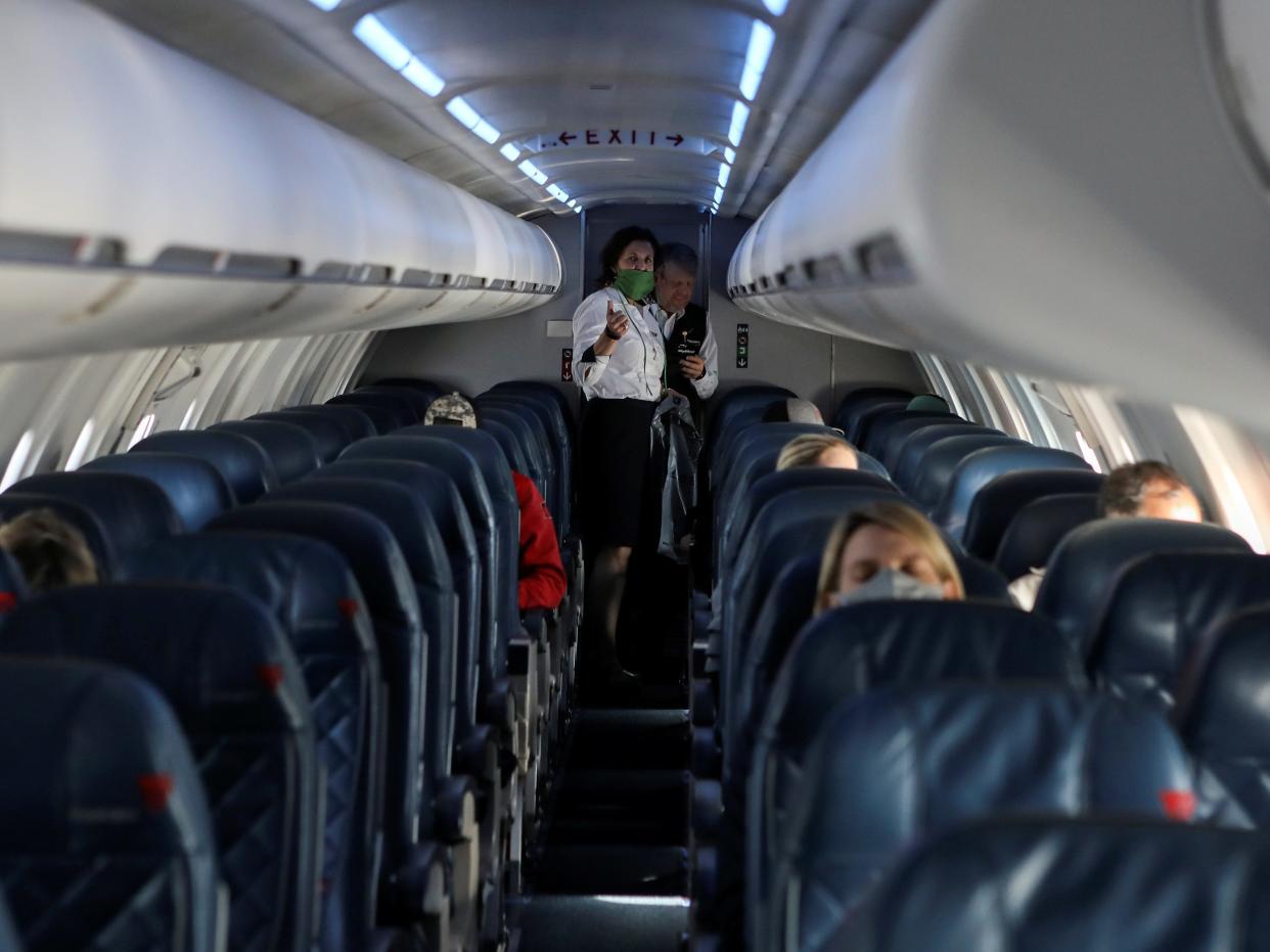 flight attendant on an airplane with passengers sleeping