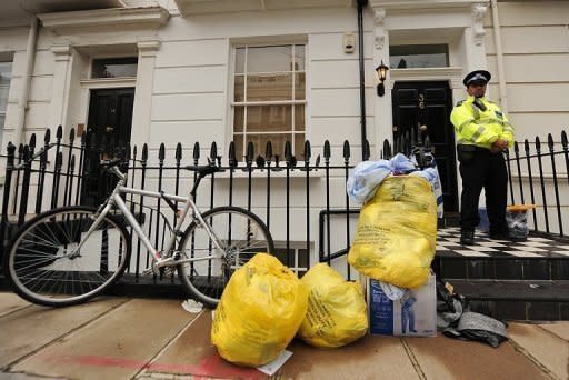 A policeman guards the entrance to a flat where the body of Gareth Williams was discovered in a bag in 2010. The British spy was probably unlawfully killed, a coroner has concluded on the final day of day of the inquest into his death