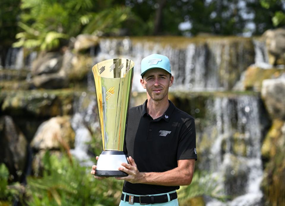 Spanish golfer David Puig with the winner's trophy at the International Series Singapore. (PHOTO: Paul Lakatos/Asian Tour)