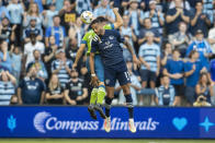 Sporting Kansas City forward Khiry Shelton goes up for a header during the first half of an MLS soccer match against the Seattle Sounders, Sunday, Sept. 26, 2021, in Kansas City, Kan. (AP Photo/Nick Tre. Smith)