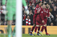Liverpool's Xherdan Shaqiri, center, celebrates with teammates Mohamed Salah, right, after scoring his side's third goal during the English Premier League soccer match between Liverpool and Newcastle at Anfield Stadium, Liverpool, England, Wednesday, Dec. 26, 2018. (AP Photo/Jon Super)