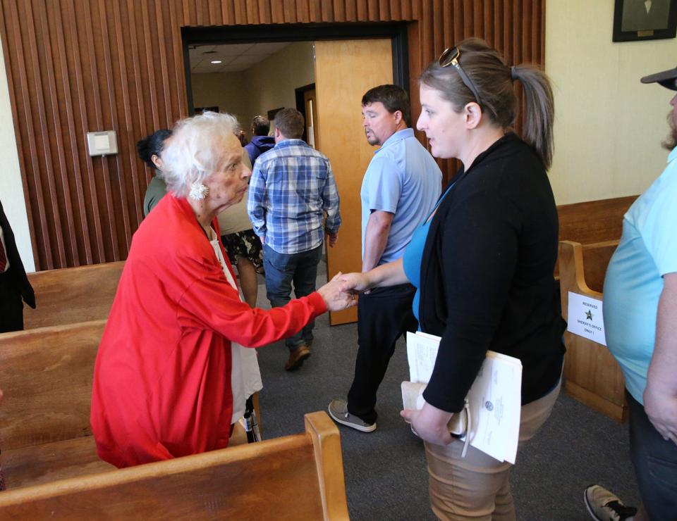 Pat Rainboth, left, executive director of Victims Inc., interacts with family members of James Hughes Sr. and Suzanne Hughes Wednesday, May 10, 2023 in Strafford County Superior Court in Dover.