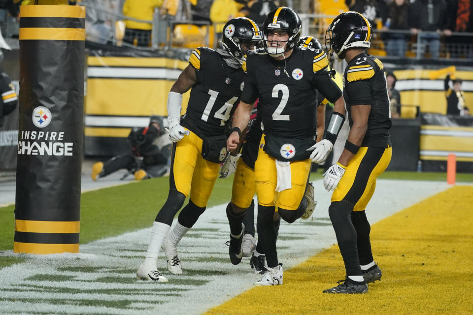 Pittsburgh Steelers quarterback Mason Rudolph (2) and Pittsburgh Steelers wide receiver George Pickens (14) and Pittsburgh Steelers wide receiver Allen Robinson II (11) celebrate Pickens scoring a touchdown during the second half of an NFL football game against the Cincinnati Bengals, Saturday, Dec. 23, 2023, in Pittsburgh. (AP Photo/Gene J. Puskar)
