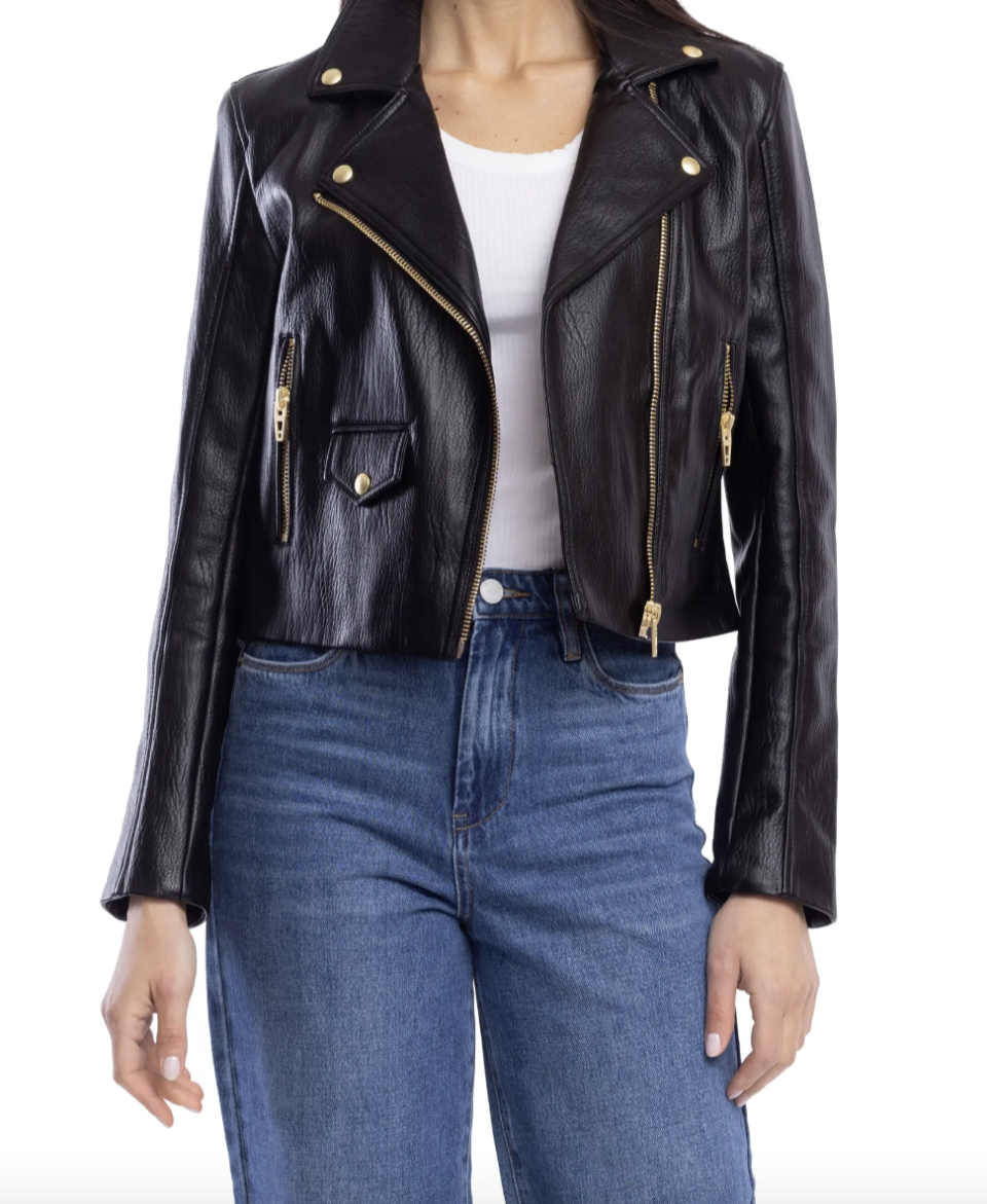 model wearing blue jeans, white t-shirt and black BlankNYC Faux Leather Moto Jacket (Photo via Nordstrom)
