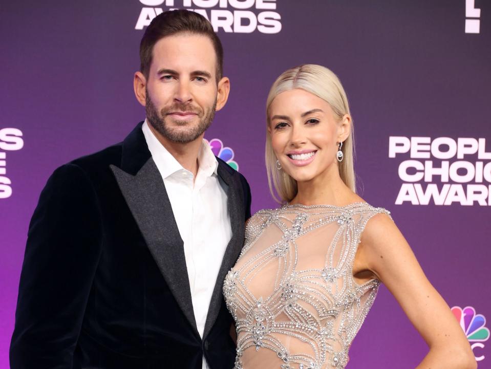Tarek El Moussa and Heather Rae El Moussa smile on the People's Choice Awards red carpet.