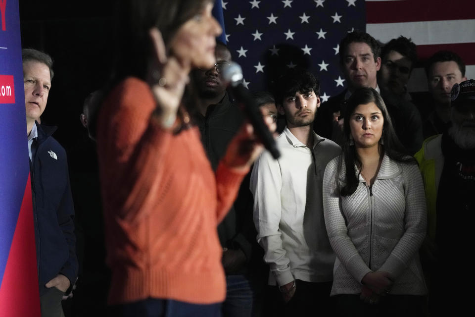 Republican presidential candidate former UN Ambassador Nikki Haley addresses a gathering, while N.H. Gov. Chris Sununu, left, and her children Rena Haley, from right, and Nalin Haley, look on at a V.F.W. hall during a campaign stop, Monday, Jan. 22, 2024, in Franklin, N.H. (AP Photo/Charles Krupa)