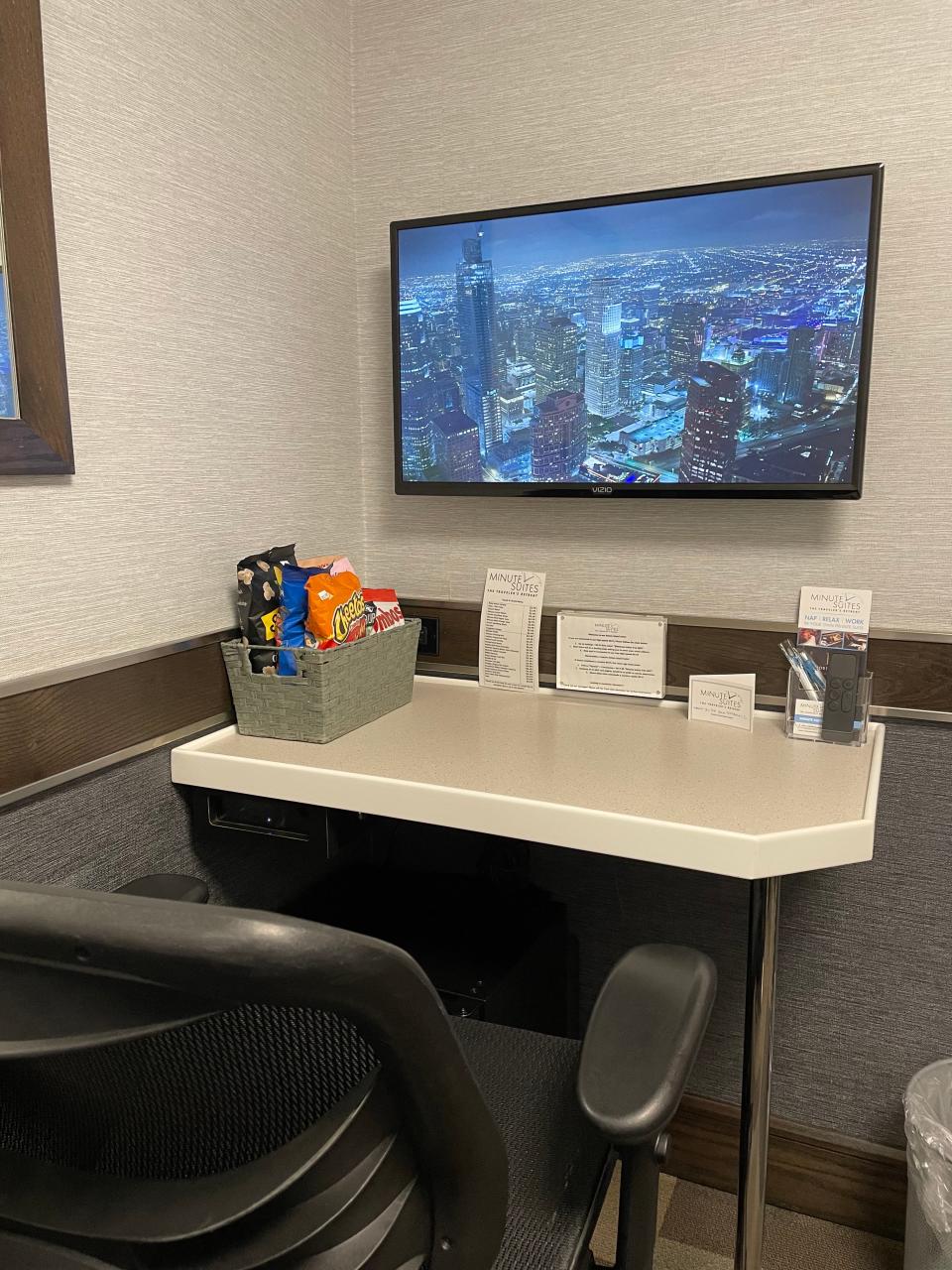 Minute Suites Express  — desk with TV above it and chair in front of it