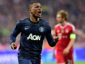 Manchester United's Patrice Evra, left, celebrates his side's opening goal during the Champions League quarterfinal second leg soccer match between Bayern Munich and Manchester United in the Allianz Arena in Munich, Germany, Wednesday, April 9, 2014. At right is Bayern's Philipp Lahm. (AP Photo/Kerstin Joensson)