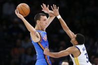 Oklahoma City Thunder forward Aleksej Pokusevski, left, passes around Golden State Warriors guard Jordan Poole (3) in the first half of an NBA basketball game Tuesday, Oct. 26, 2021, in Oklahoma City. (AP Photo/Nate Billings)