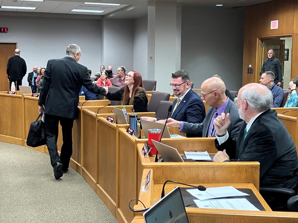 Green Bay City Council Member Chris Wery, standing, shakes hands with new Council Member Alyssa Proffitt before Tuesday's council meeting.