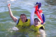 <p>Hannah Mills (left) and Eilidh McIntyre (right) of Team Great Britain jump into the water after winning gold in the Women's 470 class medal race at Enoshima Yacht Harbour on August 4.</p>