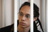 FILE - WNBA star and two-time Olympic gold medalist Brittney Griner sits in a cage at a court room prior to a hearing, in Khimki just outside Moscow, Russia, Wednesday, July 27, 2022. Now that she’s back in the U.S., Griner plans to be out of the public spotlight for awhile spending time with her wife. She hasn’t said if she’ll ever play basketball again. (AP Photo/Alexander Zemlianichenko, Pool, File)