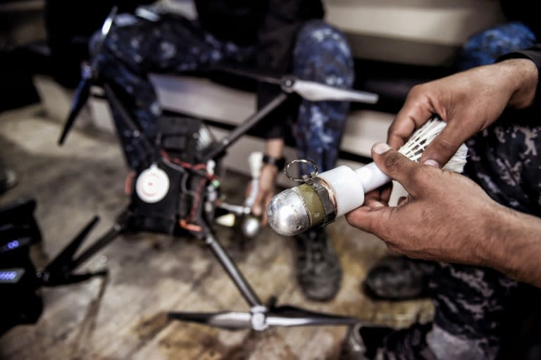 A member of Iraqi forces holds a grenade on March 14, 2017 which is to be attached to a drone in the fight against jihadists in Mosul