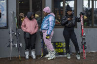 Kafi Mojapelo, right, who traveled the short distance from neighboring South Africa to the Afriski ski resort, waits for her ski instructor, near Butha-Buthe, Lesotho, Saturday July 30, 2022. While millions across Europe sweat through a summer of record-breaking heat, Afriski in the Maluti Mountains is Africa's only operating ski resort south of the equator. It draws people from neighboring South Africa and further afield by offering a unique experience to go skiing in southern Africa. (AP Photo/Jerome Delay)