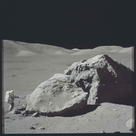 Scientist-astronaut Harrison H. Schmitt is photographed standing next to a huge, split boulder during the third Apollo 17 extravehicular activity (EVA) at the Taurus-Littrow landing site on the moon during the Apollo 17 mission in this December 13, 1972 NASA handout photo. The photograph is one of more than 12,000 from NASA's archives recently aggregated on the Project Apollo Archive Flickr account. REUTERS/NASA/Handout via Reuters THIS IMAGE HAS BEEN SUPPLIED BY A THIRD PARTY. IT IS DISTRIBUTED, EXACTLY AS RECEIVED BY REUTERS, AS A SERVICE TO CLIENTS. FOR EDITORIAL USE ONLY. NOT FOR SALE FOR MARKETING OR ADVERTISING CAMPAIGNS