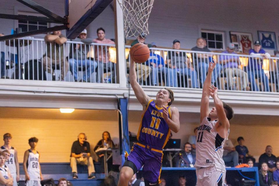 Lyon County’s Travis Perry, left, get to the rim against Floyd Central’s during a game at Wayland Gymnasium at the Mountain Sports Hall of Fame on Dec. 16. Perry is a 2024 UK basketball signee and the all-time leading scorer in Kentucky boys high school basketball history.