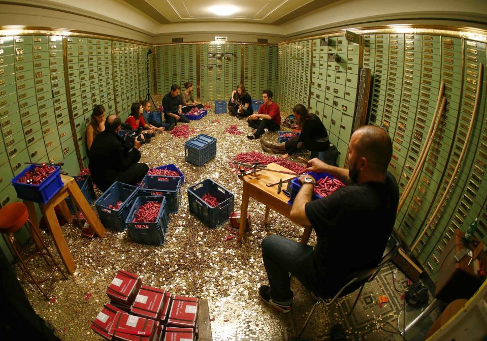 Committee members for 'Grundeinkommen' open rolls of five cent coins in the old vault of the former Schweizerische Volksbank in Basel