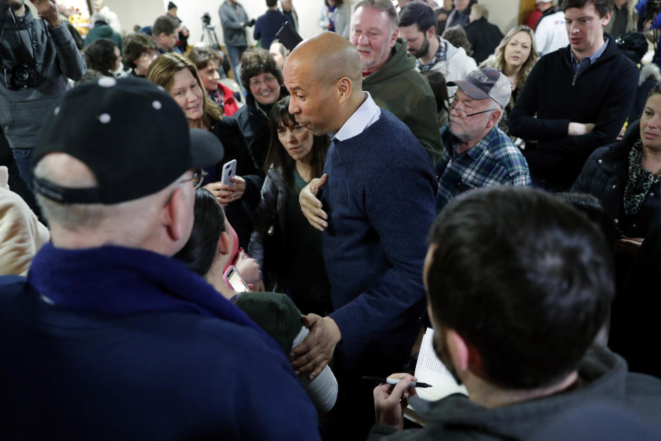 U.S. Sen. Cory Booker, D-N.J., center, speaks to local residents during a meet and greet at the First Congregational United Church of Christ, Friday, Feb. 8, 2019, in Mason City, Iowa. (AP Photo/Charlie Neibergall)