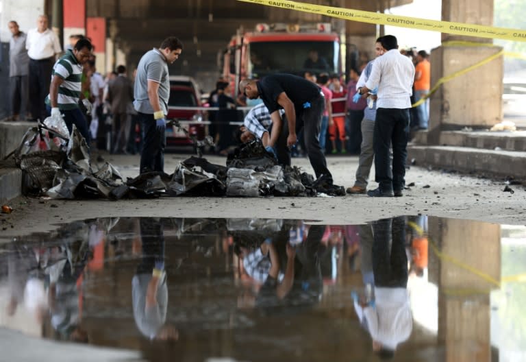 Explosive experts check debris following a powerful bomb explosion that ripped through the Italian consulate, killing one person, in Cairo, July 11, 2015