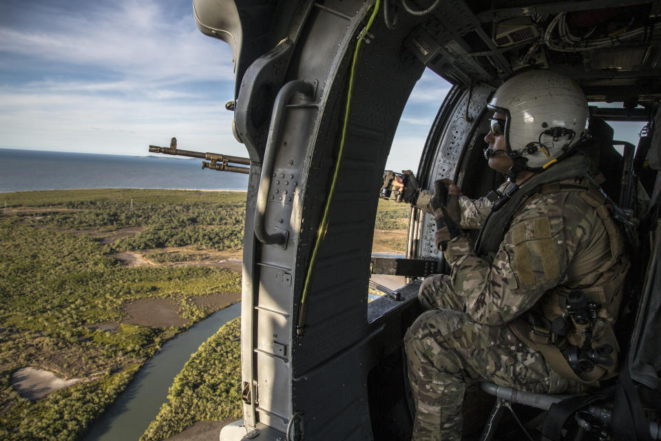 A supplied image obtained on Tuesday, July 16, 2019, shows a crew chief with Helicopter Sea Combat Squadron 85 (HSC-85) scanning the skies while on a mission to emplace U.S. and Australian Special Operations Forces (SOF) during Talisman Sabre, July 12, 2019. Talisman Sabre is a bilateral exercise that tests the two forces combat training, readiness and interoperability. (AAP Image/U.S. Marine Corps, Lance Cpl. Nicole Rogge) NO ARCHIVING, EDITORIAL USE ONLY