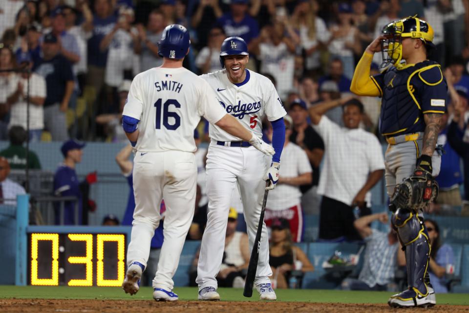 Jul 5, 2024; Los Angeles, California, USA; Los Angeles Dodgers catcher Will Smith (16) is greeted by first baseman Freddie Freeman (5) after hitting a third home run of the game during the seventh inning against the Milwaukee Brewers at Dodger Stadium. Mandatory Credit: Kiyoshi Mio-USA TODAY Sports