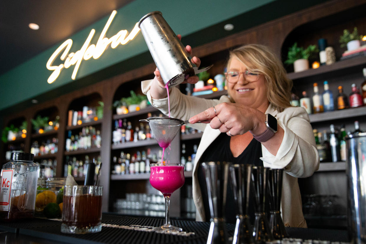 Danni Smith, managing partner at Sidebar in downtown South Bend, prepares a cocktail. The cocktail bar recently opened in the Barnes & Thornburg building.