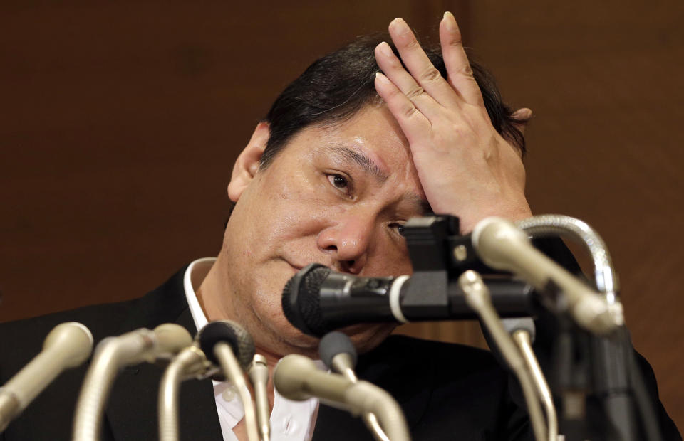 Mamoru Samuragochi gestures during a press conference in Tokyo, Friday, March 7, 2014. The man once lauded as "Japan's Beethoven" bowed repeatedly and apologized Friday at his first media appearance since it was revealed last month that his famed musical compositions were ghostwritten and he wasn't completely deaf. (AP Photo/Shuji Kajiyama)