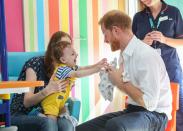 <p>Prince Harry plays with a young child during a visit to Sheffield Children’s Hospital.</p>