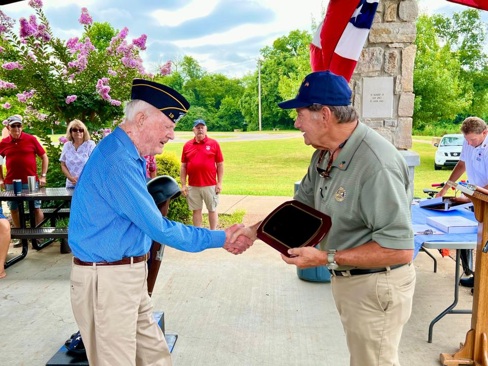 Eddie Ables, right, presents a commemorative plaque to World War II veteran George Horne during the annual 4th of July celebration at Riverwalk Park.