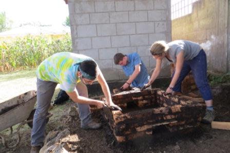 James, Tucker, and Rachel building the charcoal kiln.