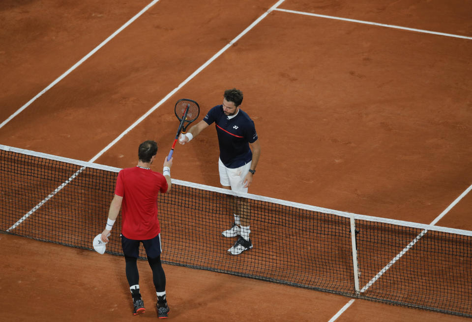 Britain's Andy Murray congratulates Switzerland's Stan Wawrinka after Murray lost in three sets 1-6, 3-6, 2-6, in the first round match of the French Open tennis tournament at the Roland Garros stadium in Paris, France, Sunday, Sept. 27, 2020. (AP Photo/Christophe Ena)