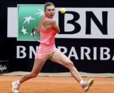 Simona Halep of Romania returns the ball to Carla Suarez Navarro of Spain during their women's semi-final match at the Rome Open tennis tournament in Rome, Italy, May 16, 2015. REUTERS/Stefano Rellandini