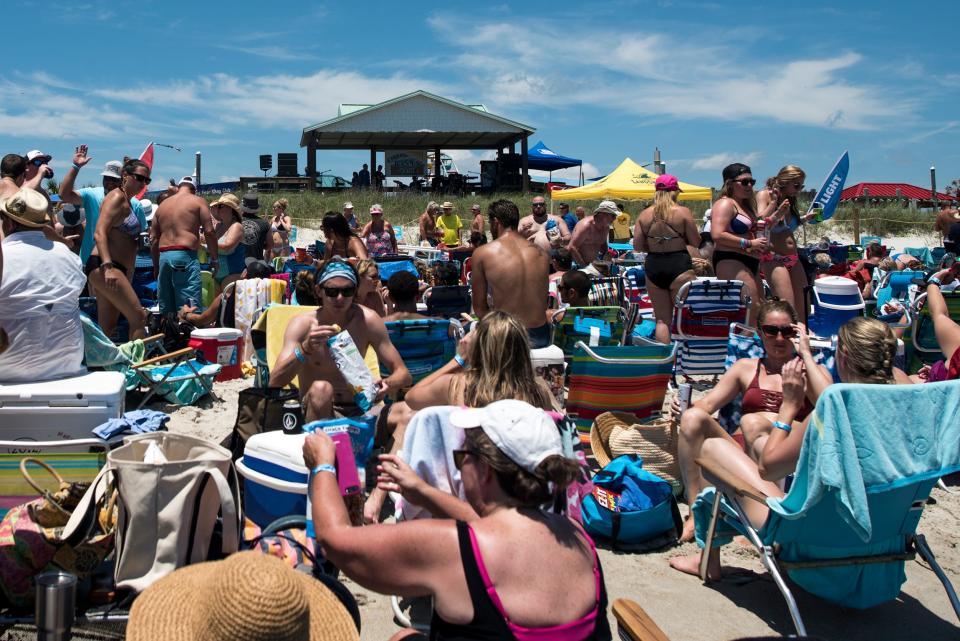 People listen to music on the beach and in the water at the Carolina Beach Music Festival at Carolina Beach on Saturday, June 2, 2018. The Beach Music Festival is billed as "the biggest and only beach music festival actually held on the beach on the North Carolina coast" and one of the longest running beach music festivals in the United States.