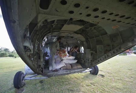 Men load relief material onto an Indian Air Force (IAF) helicopter that is to be delivered to flood victims in remote areas, at Reasi, northwest of Jammu September 12, 2014. REUTERS/Mukesh Gupta