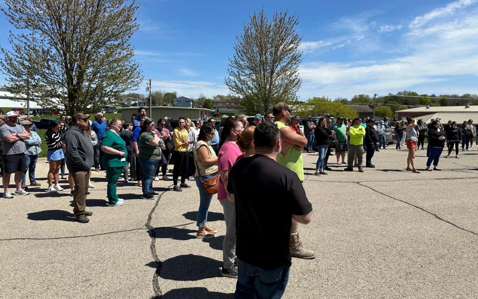 Parents wait for their children outside after the school was put on lockdown