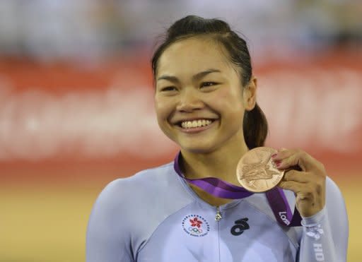 Hong Kong's Lee Wai-Sze poses on the podium after winning the bronze medal in the London 2012 Olympic Games women's Keirin final track cycling event at the Veldorome in the Olympic Park in East London, on August 3