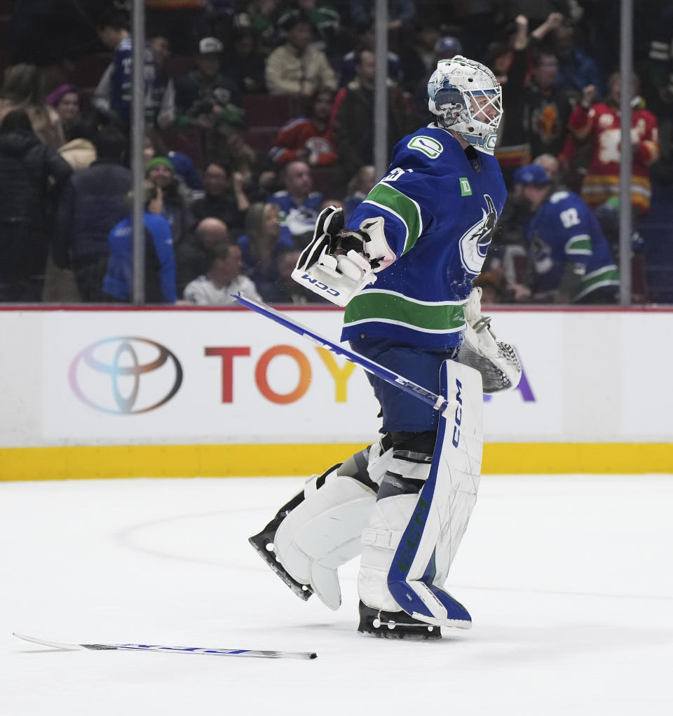 Vancouver Canucks goalie Thatcher Demko breaks his stick after allowing an overtime goal to the Calgary Flames in an NHL hockey game Friday, March 31, 2023, in Vancouver, British Columbia. (Darryl Dyck/The Canadian Press via AP)