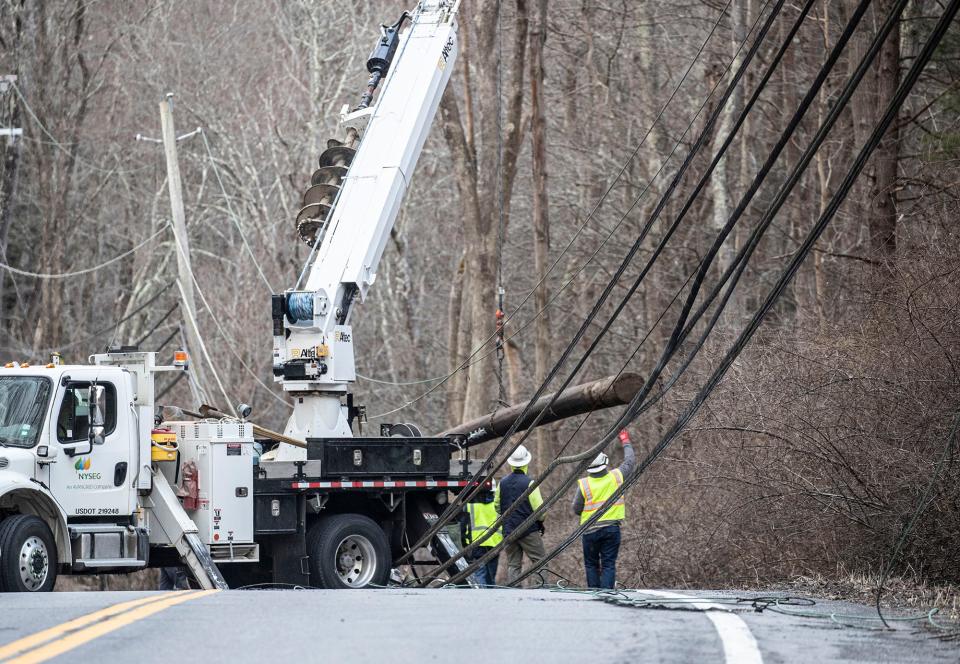 Workers clear downed power lines on route 172 in Bedford March 11, 2024. Route 172 was closed at Pine Brook Road and Loop Road through the morning.