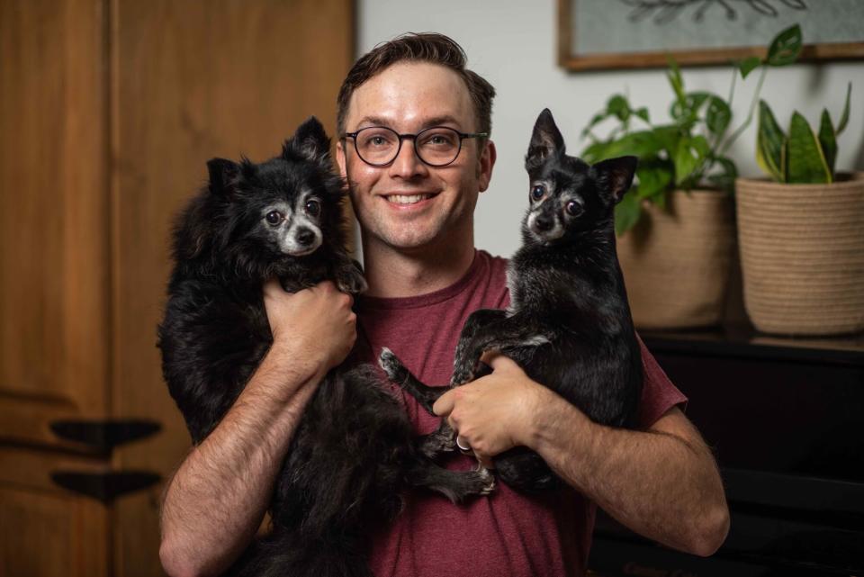 Matt Hobbs holds his two pups Marley and Leni