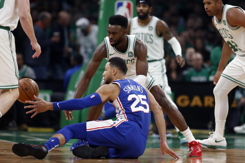 Philadelphia 76ers' Ben Simmons (25) battles Boston Celtics' Jaylen Brown for a loose ball during the first half of an NBA basketball game in Boston, Tuesday, Oct 16, 2018. (AP Photo/Michael Dwyer)