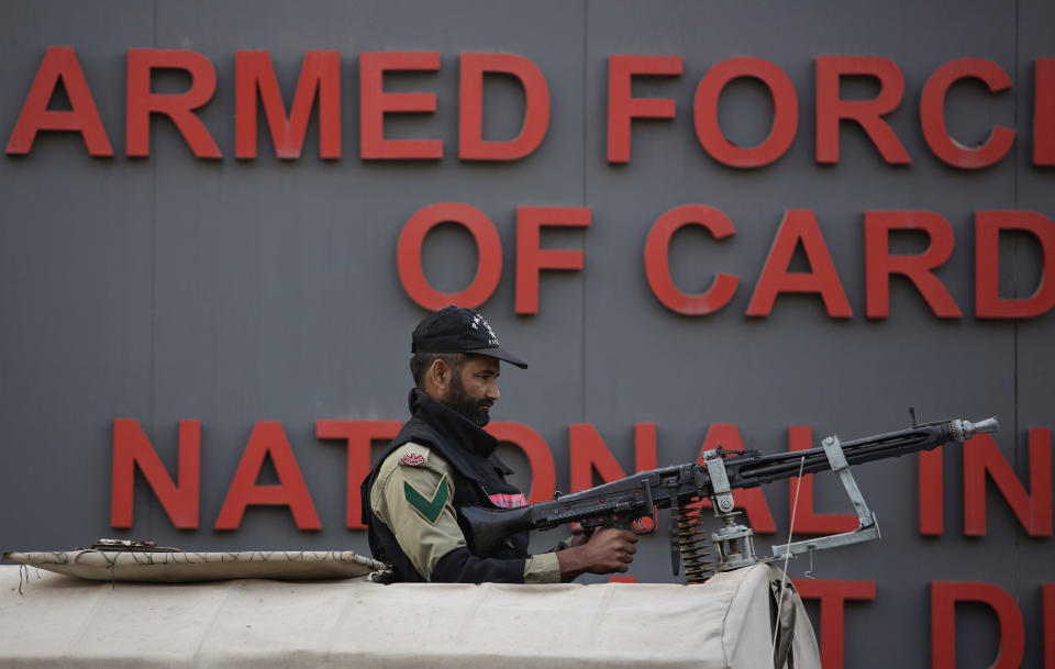 A soldier of the Pakistani paramilitary forces stands alert as security is beefed up outside the Armed Forces Institute of Cardiology where Pakistan's former president and military ruler Pervez Musharraf is admitted in Rawalpindi, Pakistan, Friday, Jan. 3, 2014. Musharraf was rushed to a hospital on Thursday with a heart problem he experienced while on his way to a court hearing in the high treason case, police and lawyers said. (AP Photo/B.K. Bangash)