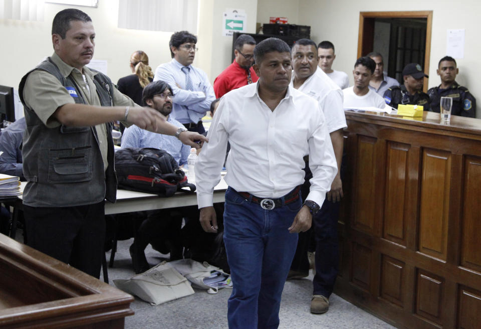 The men accused in the killing prize-winning Honduran indigenous and environmental rights activist Berta Caceres enter the court room in Tegucigalpa, Honduras, Monday, Sept. 17, 2018. Honduras' supreme court has indefinitely suspended the start of the trial of eight men accused in the 2016 killing of Caceres, citing five related filings pending at the criminal appeals court that have to be resolved. (AP Photo/Fernando Antonio)