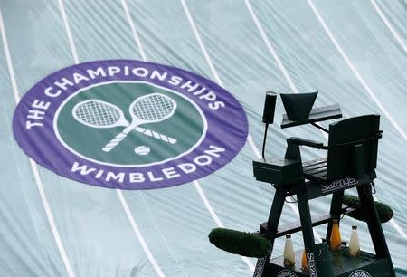 The rain covers protect a court at the Wimbledon Tennis Championships, in London June 28, 2013. REUTERS/Eddie Keogh